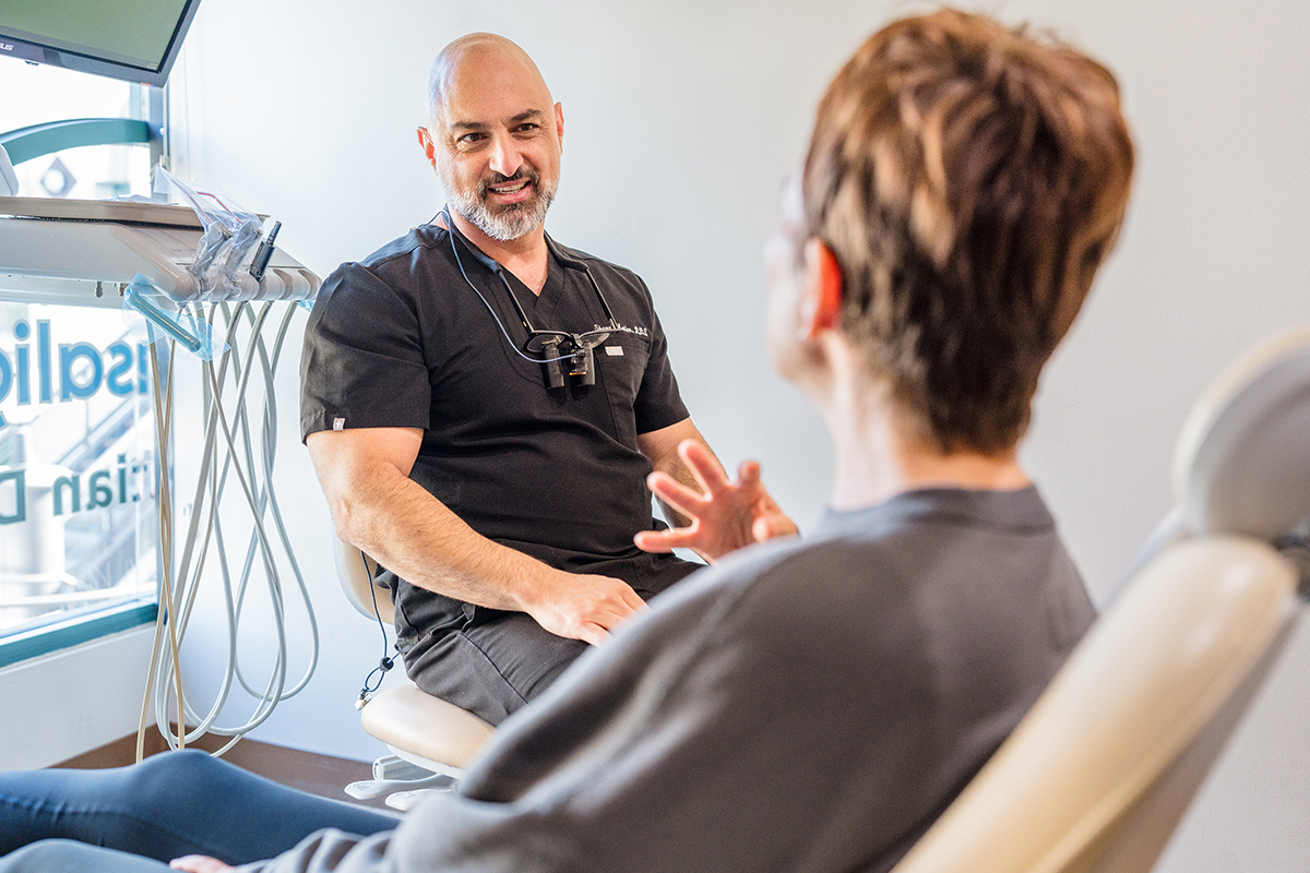 Dentist consulting a patient on veneers at BioDental in Encino.